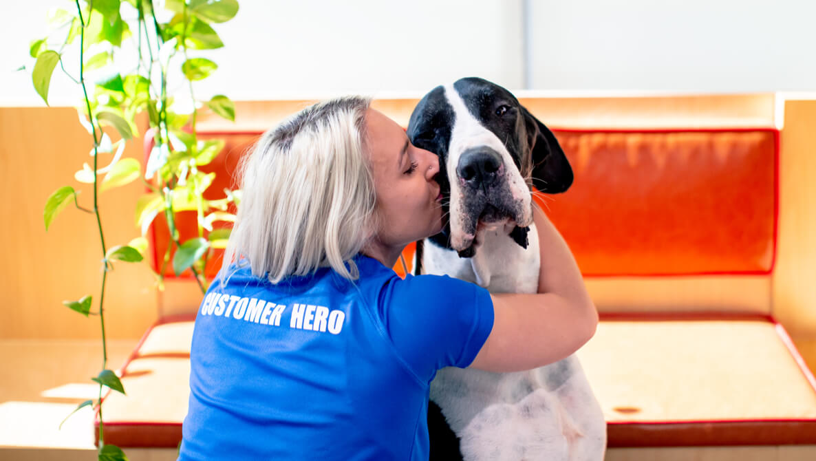 Woman kissing her dog