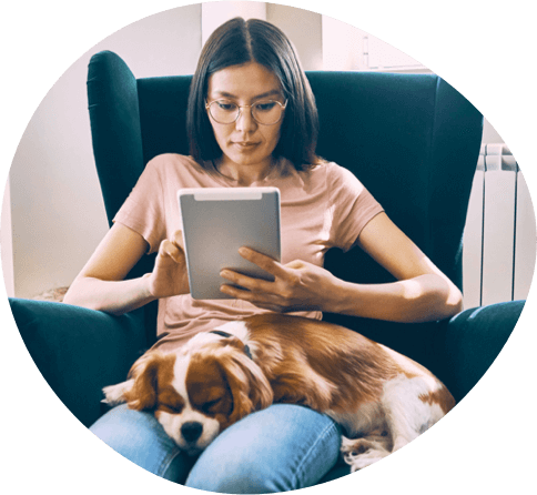 woman with her pet looking at a tablet
